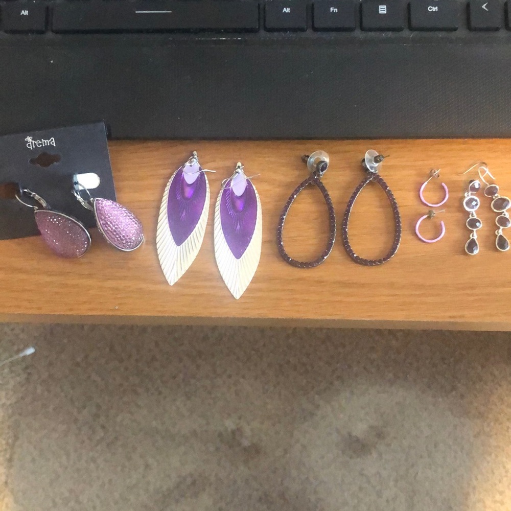Six pair of purple earrings